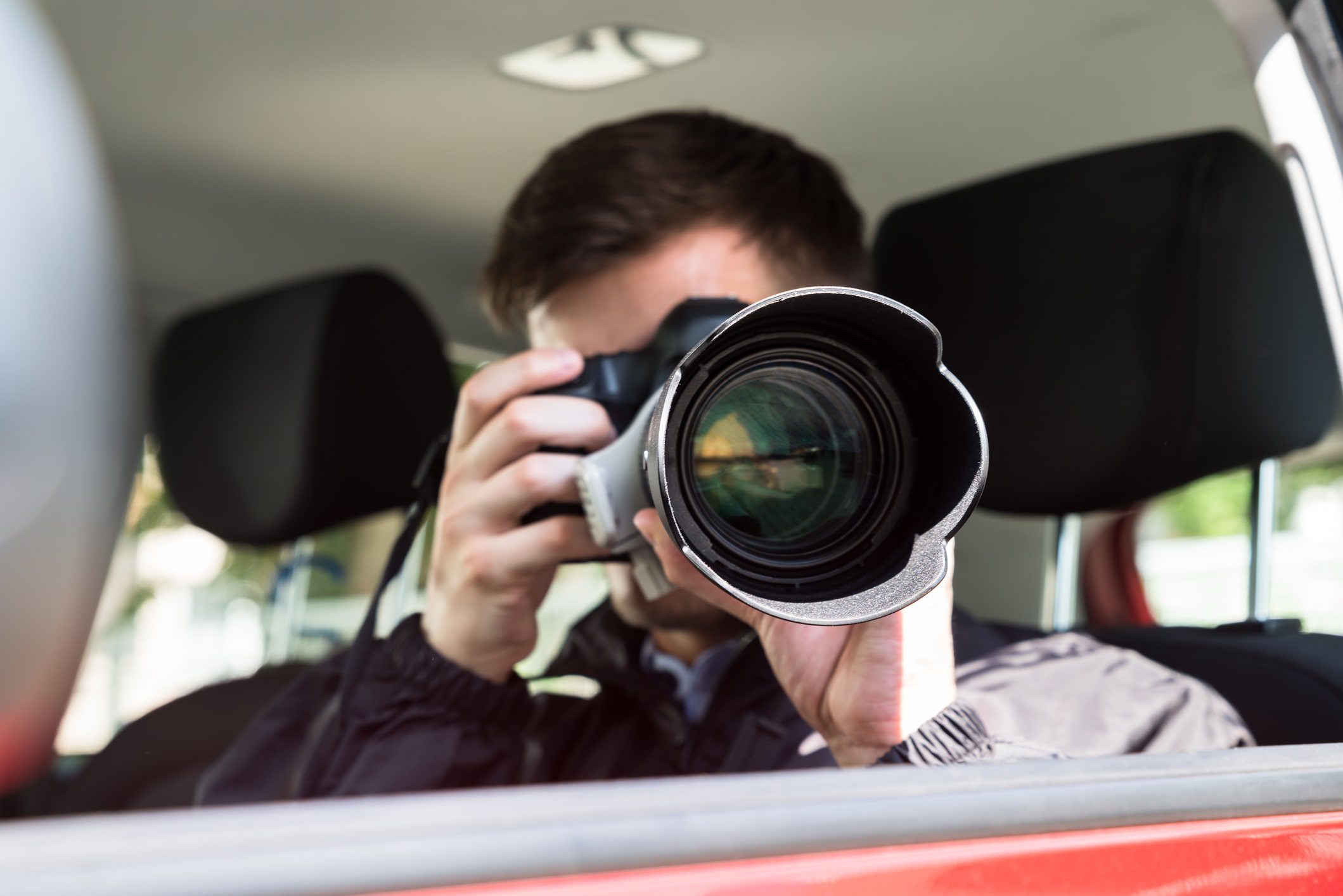 GettyImages-928081054-min A man taking a picture of himself in the back seat.